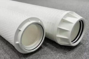 A pressure gauge on a filter housing showing the needle in the red change zone