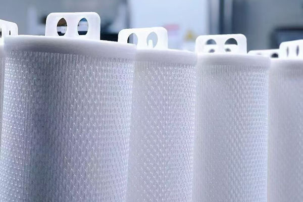 An Ecofiltrone HFK Series high-flow filter cartridge being installed into a stainless steel housing