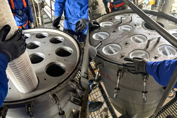 A technician replacing a clogged high-flow filter cartridge in a desalination plant
