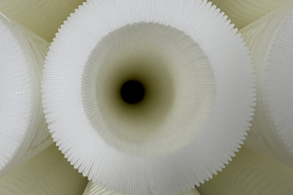 A high-flow filter cartridge being inspected for quality.